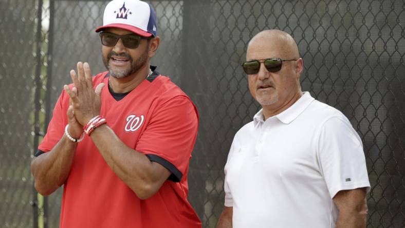 Feb 13, 2020; West Palm Beach, Florida, USA; Washington Nationals manager Dave Martinez (4) and general manager Mike Rizzo watch the pitchers warm up during a  spring training workout at FITTEAM Ballpark. Mandatory Credit: Rhona Wise-USA TODAY Sports