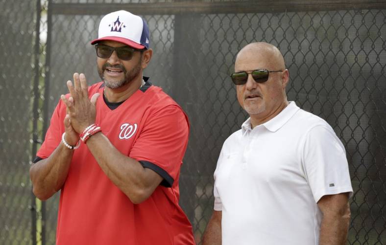Feb 13, 2020; West Palm Beach, Florida, USA; Washington Nationals manager Dave Martinez (4) and general manager Mike Rizzo watch the pitchers warm up during a  spring training workout at FITTEAM Ballpark. Mandatory Credit: Rhona Wise-USA TODAY Sports