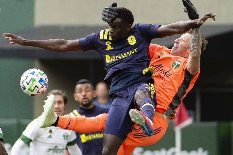 Mar 8, 2020; Portland, Oregon, USA; Portland Timbers goalkeeper Steve Clark (12) defends the goal during the second half against Nashville SC forward Dominique Badji (9) at Providence Park. The Timbers won 1-0. Mandatory Credit: Troy Wayrynen-USA TODAY Sports