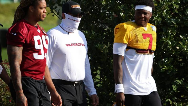 Aug 20, 2020; Ashburn, Virginia, USA; Washington Football Team defensive end Chase Young (99), head coach Ron Rivera (M), and quarterback Dwayne Haskins Jr. (7) walk to the field prior to day twenty-three of training camp at Inova Sports Performance Center in Ashburn, Virginia. Mandatory Credit: Geoff Burke-USA TODAY Sports