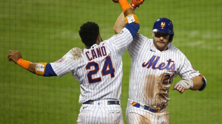 Sep 9, 2020; New York City, New York, USA; New York Mets designated hitter Pete Alonso (20) celebrates his solo go ahead home run against the Baltimore Orioles with second baseman Robinson Cano (24) during the eighth inning at Citi Field. Mandatory Credit: Brad Penner-USA TODAY Sports