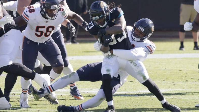 Dec 27, 2020; Jacksonville, Florida, USA; Chicago Bears linebacker Robert Quinn (94) tackles Jacksonville Jaguars running back Dare Ogunbowale (33) as Bears linebacker Roquan Smith (58) looks on during the second quarter at TIAA Bank Field. Mandatory Credit: Reinhold Matay-USA TODAY Sports