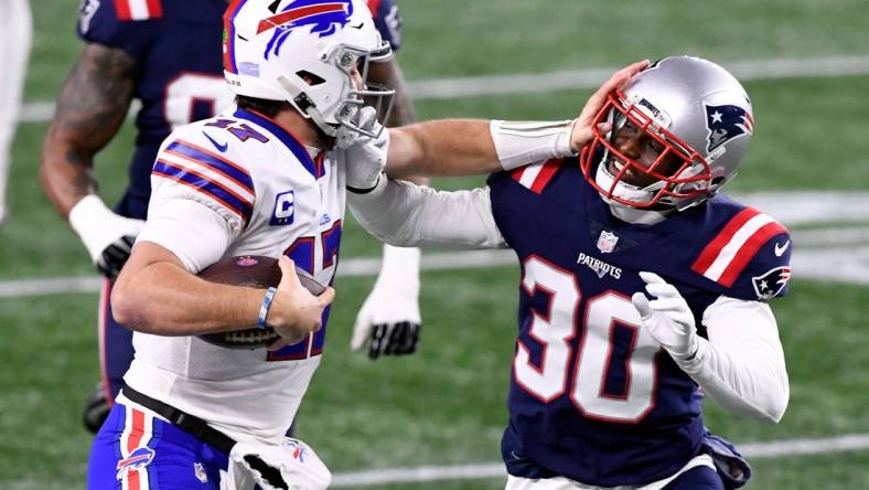 Dec 28, 2020; Foxborough, Massachusetts, USA; Buffalo Bills quarterback Josh Allen (17) rushes against New England Patriots cornerback Jason McCourty (30) during the second quarter at Gillette Stadium. Mandatory Credit: Brian Fluharty-USA TODAY Sports