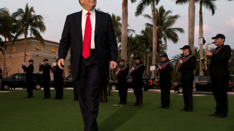 President Donald Trump listens to the Palm Beach Central band as he arrives at Trump International Golf Club to watch the Super Bowl in West Palm Beach, Florida on February 5, 2017.