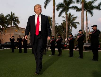 President Donald Trump listens to the Palm Beach Central band as he arrives at Trump International Golf Club to watch the Super Bowl in West Palm Beach, Florida on February 5, 2017.