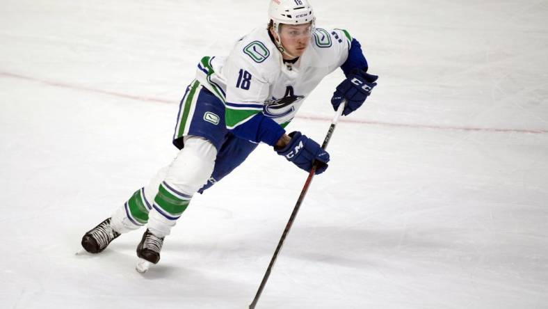 Mar 15, 2021; Ottawa, Ontario, CAN; Vancouver Canucks right wing Jake Virtanen (18) skates with the puck in the third period against the Ottawa Senators at the Canadian Tire Centre. Mandatory Credit: Marc DesRosiers-USA TODAY Sports