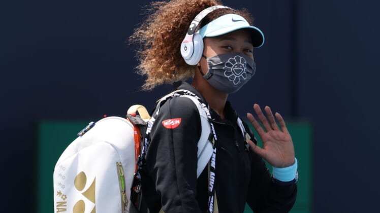 Mar 26, 2021; Miami, Florida, USA; Naomi Osaka of Japan waves while walking onto the court prior to her match against Ajla Tomljanovic of Australia (not pictured) in the second round in the Miami Open at Hard Rock Stadium. Mandatory Credit: Geoff Burke-USA TODAY Sports