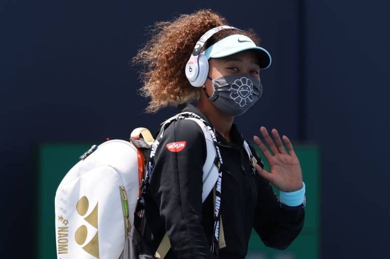 Mar 26, 2021; Miami, Florida, USA; Naomi Osaka of Japan waves while walking onto the court prior to her match against Ajla Tomljanovic of Australia (not pictured) in the second round in the Miami Open at Hard Rock Stadium. Mandatory Credit: Geoff Burke-USA TODAY Sports
