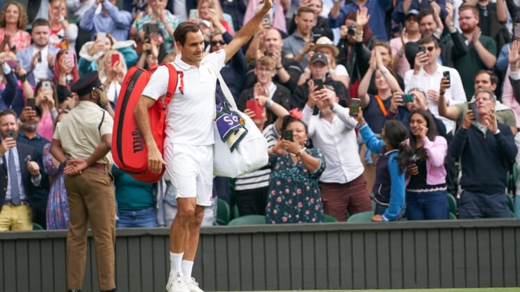 Jul 7, 2021; London, United Kingdom; Roger Federer (SUI) waving farewell to the Centre Court fans after losing to Hubert Hurkacz (POL) in the quarter finals at All England Lawn Tennis and Croquet Club. Mandatory Credit: Peter van den Berg-USA TODAY Sports