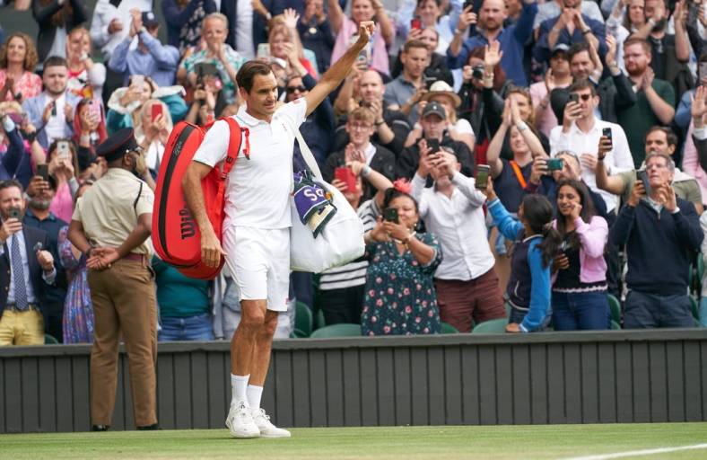 Jul 7, 2021; London, United Kingdom; Roger Federer (SUI) waving farewell to the Centre Court fans after losing to Hubert Hurkacz (POL) in the quarter finals at All England Lawn Tennis and Croquet Club. Mandatory Credit: Peter van den Berg-USA TODAY Sports