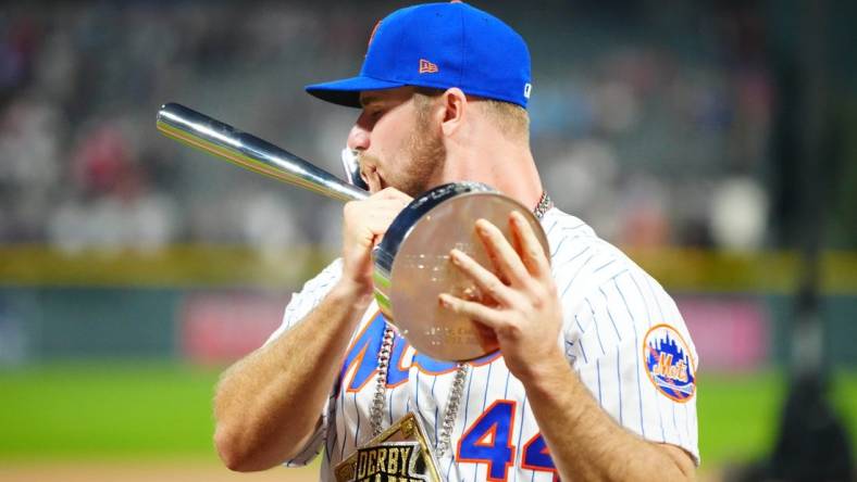 Jul 12, 2021; Denver, CO, USA; New York Mets first baseman Pete Alonso poses for photographs with the winners trophy following his victory in the 2021 MLB Home Run Derby. Mandatory Credit: Mark J. Rebilas-USA TODAY Sports