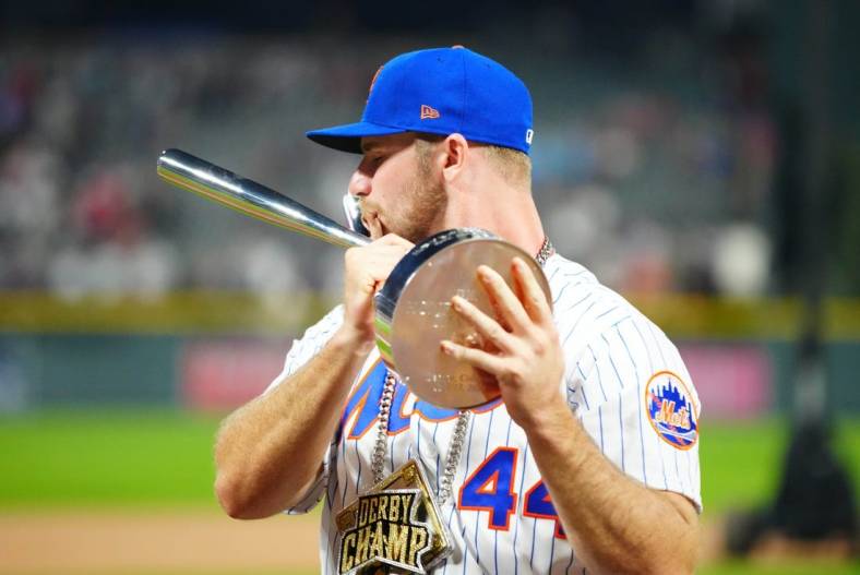 Jul 12, 2021; Denver, CO, USA; New York Mets first baseman Pete Alonso poses for photographs with the winners trophy following his victory in the 2021 MLB Home Run Derby. Mandatory Credit: Mark J. Rebilas-USA TODAY Sports