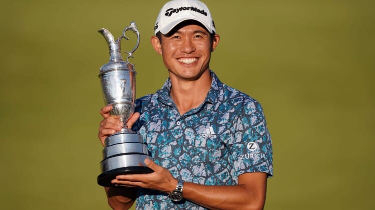 Jul 18, 2021; Sandwich, England, GBR; Collin Morikawa celebrates with the Claret Jug on the 18th green following his final round winning the Open Championship golf tournament. Mandatory Credit: Peter van den Berg-USA TODAY Sports