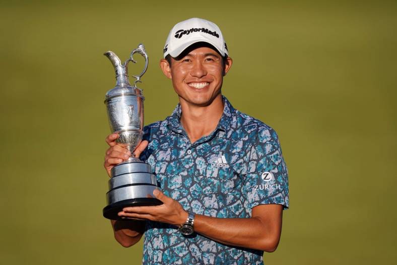 Jul 18, 2021; Sandwich, England, GBR; Collin Morikawa celebrates with the Claret Jug on the 18th green following his final round winning the Open Championship golf tournament. Mandatory Credit: Peter van den Berg-USA TODAY Sports