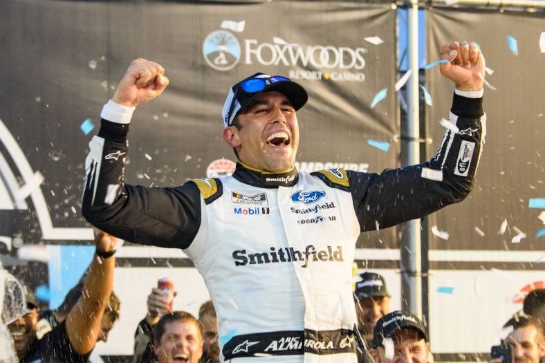 Jul 18, 2021; Loudon, New Hampshire, USA; NASCAR Cup Series driver Aric Almirola (10) celebrates after winning the Foxwoods Resort Casino 301 at the New Hampshire Motor Speedway. Mandatory Credit: Brian Fluharty-USA TODAY Sports