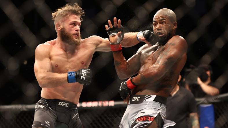 Aug 7, 2021; Houston, Texas, USA; Bobby Green (red gloves) fights Rafael Fiziev (blue gloves) during UFC 265 at Toyota Center. Mandatory Credit: Troy Taormina-USA TODAY Sports