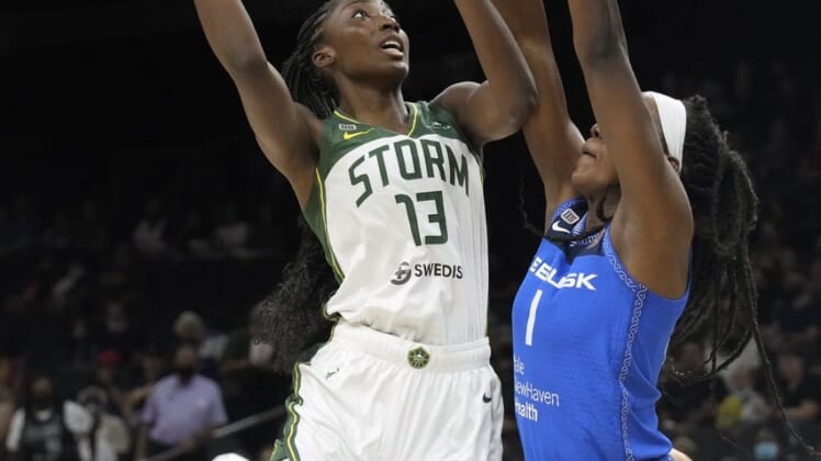 Aug 12, 2021; Phoenix, Arizona, USA; Seattle Storm center Ezi Magbegor (13) shoots the ball against Connecticut Sun forward Beatrice Mompremier (1) in the first half during the Inaugural WNBA Commissioners Cup Championship Game at Footprint Center. Mandatory Credit: Rick Scuteri-USA TODAY Sports