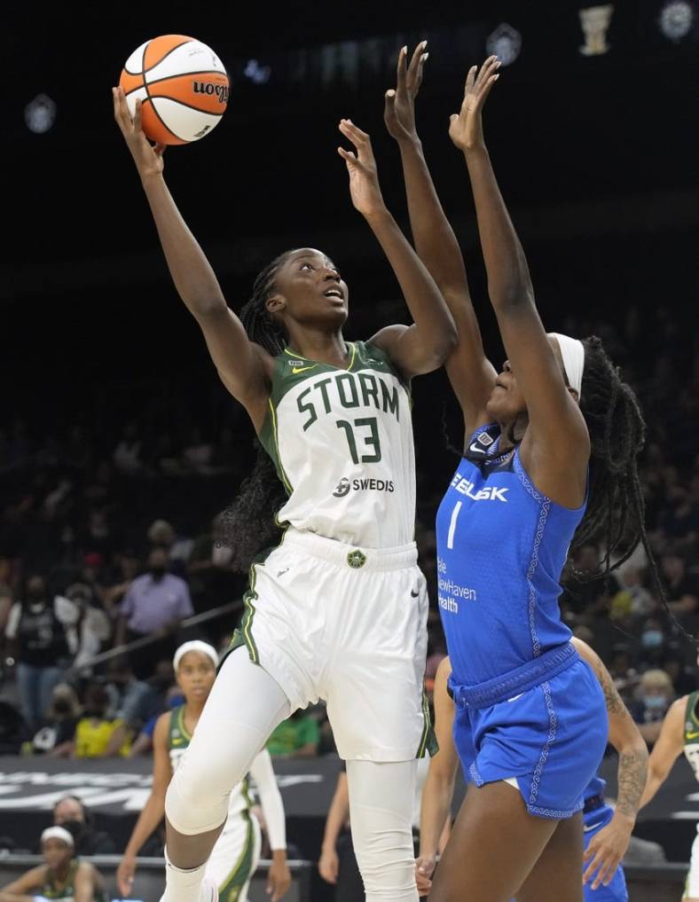 Aug 12, 2021; Phoenix, Arizona, USA; Seattle Storm center Ezi Magbegor (13) shoots the ball against Connecticut Sun forward Beatrice Mompremier (1) in the first half during the Inaugural WNBA Commissioners Cup Championship Game at Footprint Center. Mandatory Credit: Rick Scuteri-USA TODAY Sports