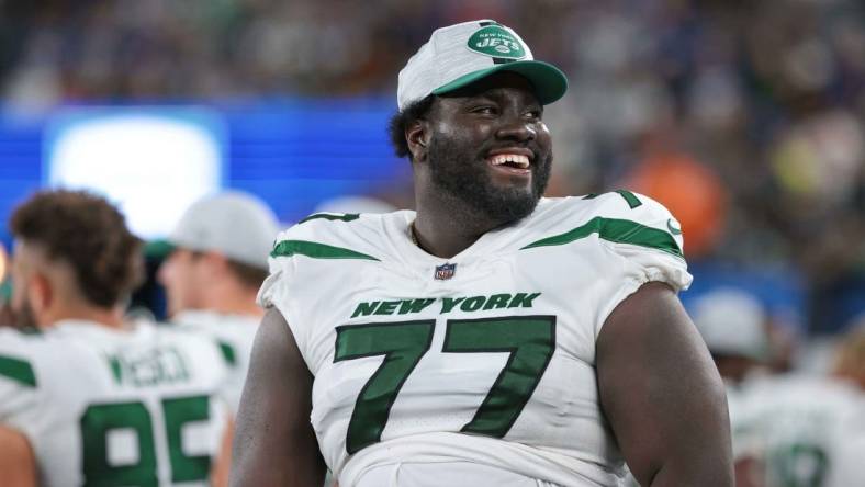 Aug 14, 2021; East Rutherford, New Jersey, USA; New York Jets offensive tackle Mekhi Becton (77) laughs during the second half against the New York Giants at MetLife Stadium. Mandatory Credit: Vincent Carchietta-USA TODAY Sports