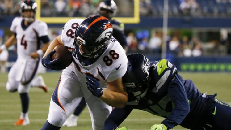 Aug 21, 2021; Seattle, Washington, USA; Denver Broncos tight end Shaun Beyer (88) scores a touchdown after making a reception against Seattle Seahawks cornerback Will Sunderland (42) during the fourth quarter at Lumen Field. Mandatory Credit: Joe Nicholson-USA TODAY Sports