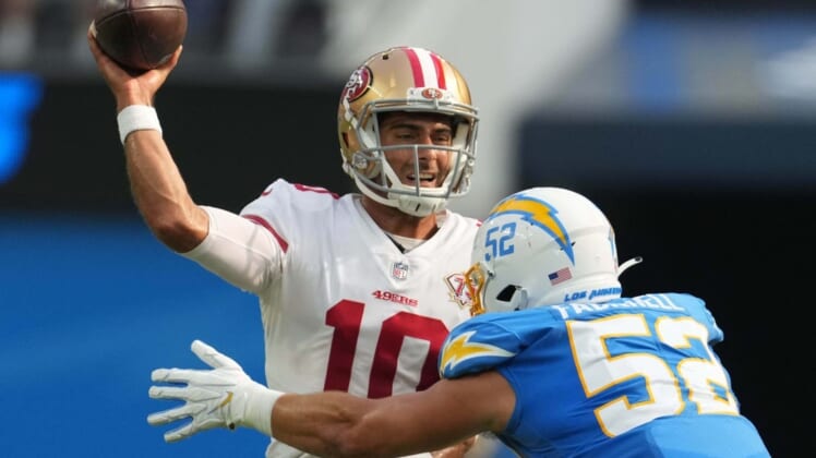 Aug 22, 2021; Inglewood, California, USA; San Francisco 49ers quarterback Jimmy Garoppolo (10) throws the ball under pressure from Los Angeles Chargers linebacker Kyler Fackrell (52) in the first quarter at SoFi Stadium. Mandatory Credit: Kirby Lee-USA TODAY Sports