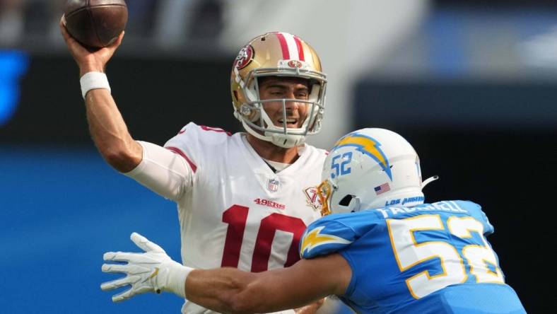 Aug 22, 2021; Inglewood, California, USA; San Francisco 49ers quarterback Jimmy Garoppolo (10) throws the ball under pressure from Los Angeles Chargers linebacker Kyler Fackrell (52) in the first quarter at SoFi Stadium. Mandatory Credit: Kirby Lee-USA TODAY Sports