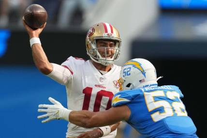 Aug 22, 2021; Inglewood, California, USA; San Francisco 49ers quarterback Jimmy Garoppolo (10) throws the ball under pressure from Los Angeles Chargers linebacker Kyler Fackrell (52) in the first quarter at SoFi Stadium. Mandatory Credit: Kirby Lee-USA TODAY Sports