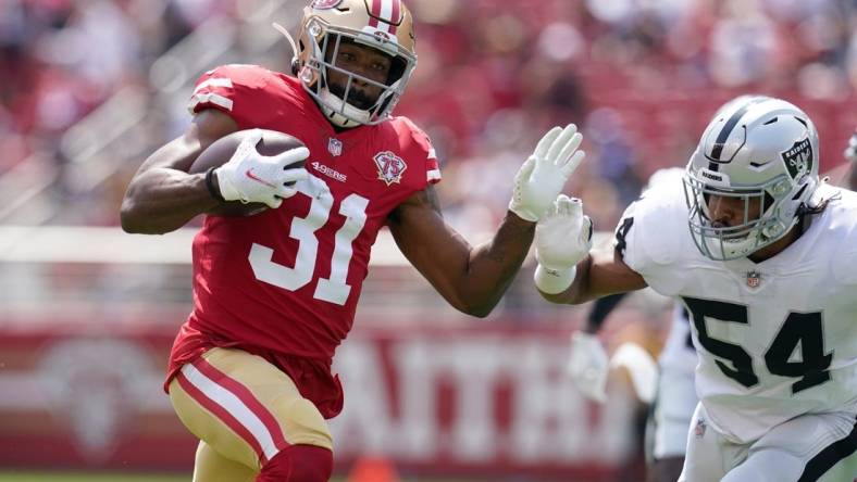 Aug 29, 2021; Santa Clara, California, USA; San Francisco 49ers running back Raheem Mostert (31) runs the ball against the Las Vegas Raiders in the first quarter at Levi's Stadium. Mandatory Credit: Cary Edmondson-USA TODAY Sports