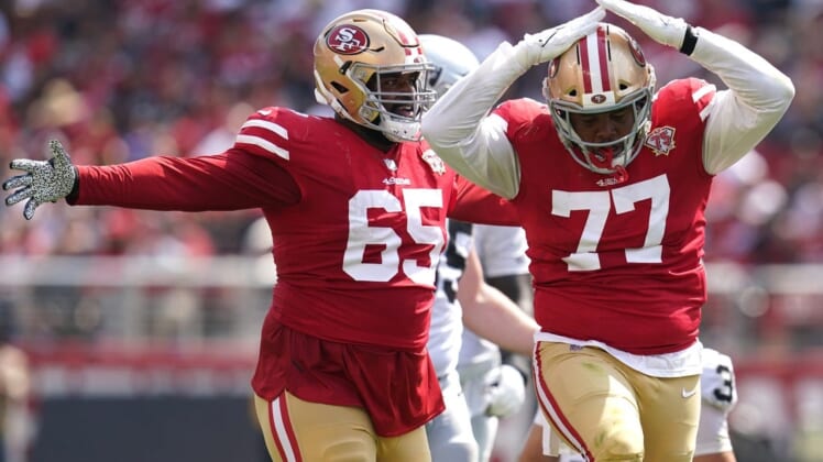 Aug 29, 2021; Santa Clara, California, USA; San Francisco 49ers offensive tackle Alfredo Gutierrez (77) celebrates next to defensive lineman Darrion Daniels (65) after making a tackle against the Las Vegas Raiders in the third quarter at Levi's Stadium. Mandatory Credit: Cary Edmondson-USA TODAY Sports