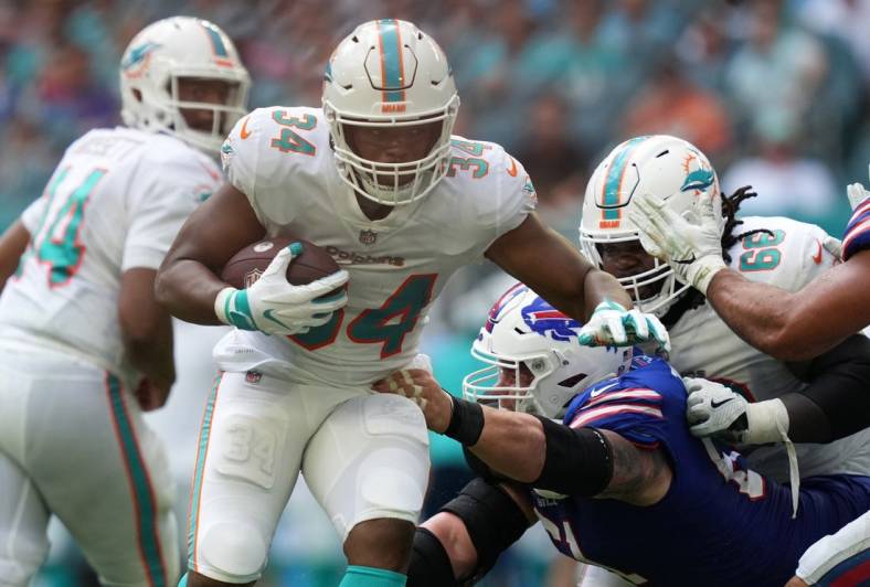 Sep 19, 2021; Miami Gardens, Florida, USA; Miami Dolphins running back Malcolm Brown (34) runs the ball against the Buffalo Bills during the first half at Hard Rock Stadium. Mandatory Credit: Jasen Vinlove-USA TODAY Sports