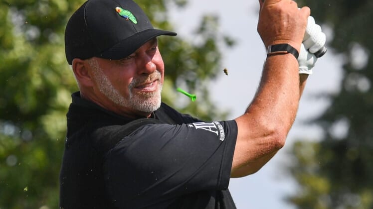 The tee kicks up near Darren Clarke's face as he tees off on the last day of the Sanford International golf tournament on Sunday, September 19, 2021, at the Minnehaha Country Club in Sioux Falls.Sanford International Finals 005