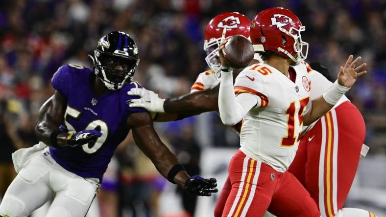 Sep 19, 2021; Baltimore, Maryland, USA;  Kansas City Chiefs quarterback Patrick Mahomes (15) throws as Baltimore Ravens linebacker Justin Houston (50) rushes during the first half at M&T Bank Stadium. Mandatory Credit: Tommy Gilligan-USA TODAY Sports