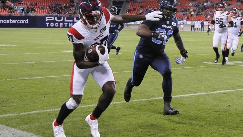 Sep 24, 2021; Toronto, Ontario, Canada; Montreal Alouettes wide receiver Eugene Lewis (87) runs down the sideline as Toronto Argonauts defensive lineman Charleston Hughes (39) chases during the first half at BMO Field. Mandatory Credit: John E. Sokolowski-USA TODAY Sports