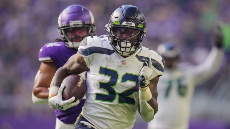 Sep 26, 2021; Minneapolis, Minnesota, USA; Seattle Seahawks running back Chris Carson (32) scores a touchdown against the Minnesota Vikings in the second quarter at U.S. Bank Stadium. Mandatory Credit: Brad Rempel-USA TODAY Sports