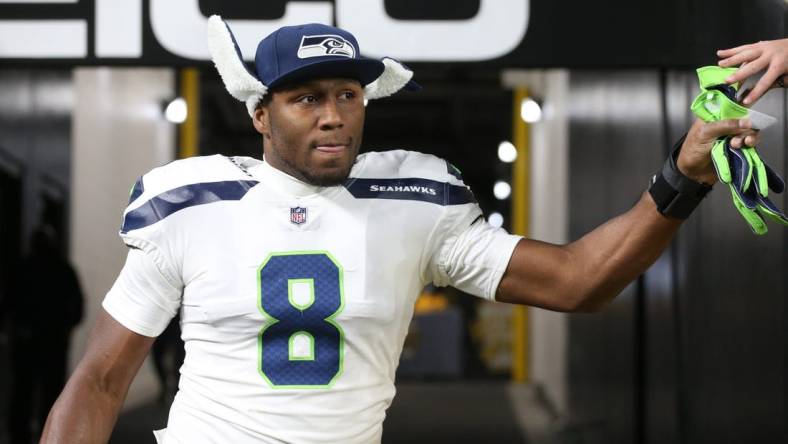 Oct 17, 2021; Pittsburgh, Pennsylvania, USA;  Seattle Seahawks defensive end Carlos Dunlap (8) high-fives a fan on his way to the field to play the Pittsburgh Steelers at Heinz Field. Mandatory Credit: Charles LeClaire-USA TODAY Sports