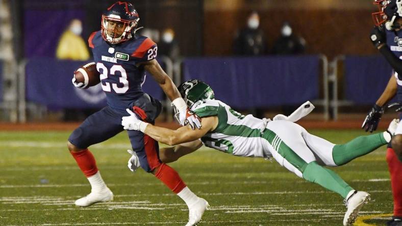 Oct 30, 2021; Montreal, Quebec, CAN; Montreal Alouettes running back Martese Jackson (23) escapes a tackle by Saskatchewan Roughriders defensive back Jacob Dearborn (33) in the second quarter during a Canadian Football League game at Molson Field. Mandatory Credit: Eric Bolte-USA TODAY Sports