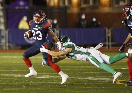 Oct 30, 2021; Montreal, Quebec, CAN; Montreal Alouettes running back Martese Jackson (23) escapes a tackle by Saskatchewan Roughriders defensive back Jacob Dearborn (33) in the second quarter during a Canadian Football League game at Molson Field. Mandatory Credit: Eric Bolte-USA TODAY Sports