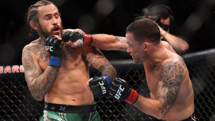 Nov 6, 2021; New York, NY, USA; Marlon Vera (blue gloves) competes against Frankie Edgar (red gloves) during UFC 268 at Madison Square Garden. Mandatory Credit: Ed Mulholland-USA TODAY Sports