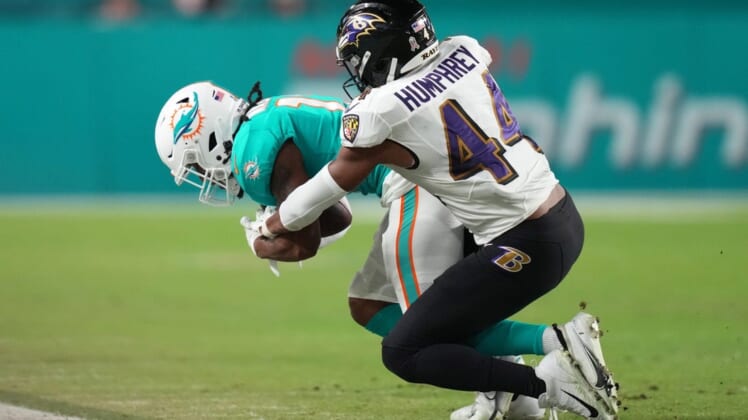 Nov 11, 2021; Miami Gardens, Florida, USA; Baltimore Ravens cornerback Marlon Humphrey (44) tackles Miami Dolphins wide receiver Jaylen Waddle (17) during the first half at Hard Rock Stadium. Mandatory Credit: Jasen Vinlove-USA TODAY Sports