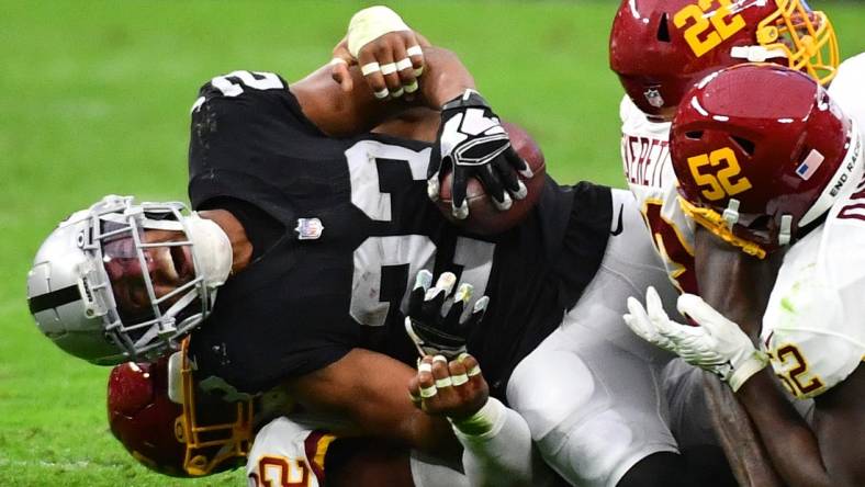 Dec 5, 2021; Paradise, Nevada, USA;Las Vegas Raiders running back Kenyan Drake (23) sustains an injury during a play against the Washington Football Team at Allegiant Stadium. Mandatory Credit: Stephen R. Sylvanie-USA TODAY Sports