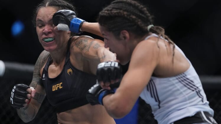 Dec 11, 2021; Las Vegas, Nevada, USA; Julianna Pena moves in with a hit against Amanda Nunes during UFC 269 at T-Mobile Arena. Mandatory Credit: Stephen R. Sylvanie-USA TODAY Sports