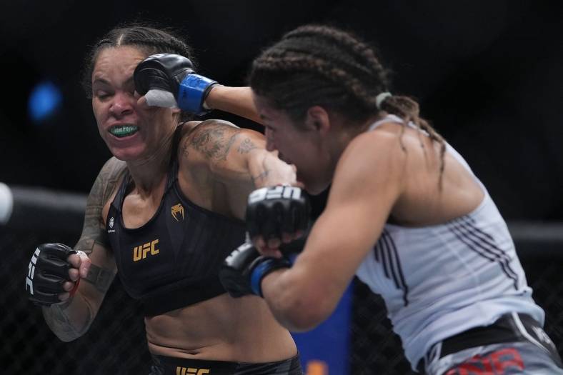 Dec 11, 2021; Las Vegas, Nevada, USA; Julianna Pena moves in with a hit against Amanda Nunes during UFC 269 at T-Mobile Arena. Mandatory Credit: Stephen R. Sylvanie-USA TODAY Sports