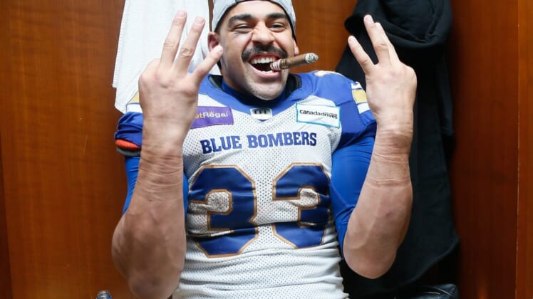 Dec 12, 2021; Hamilton, Ontario, CAN; Winnipeg Blue Bombers running back Andrew Harris (33) celebrates winning his third Grey Cup after a win over the Hamilton Tiger-Cats in the 108th Grey Cup football game at Tim Hortons Field. Mandatory Credit: John E. Sokolowski-USA TODAY Sports
