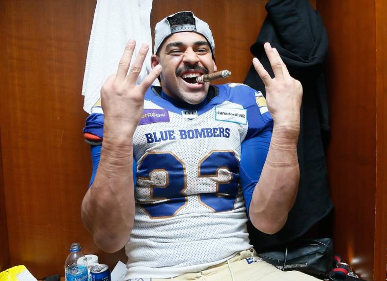 Dec 12, 2021; Hamilton, Ontario, CAN; Winnipeg Blue Bombers running back Andrew Harris (33) celebrates winning his third Grey Cup after a win over the Hamilton Tiger-Cats in the 108th Grey Cup football game at Tim Hortons Field. Mandatory Credit: John E. Sokolowski-USA TODAY Sports