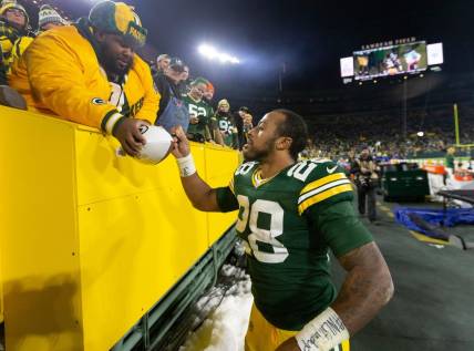 Green Bay Packers running back AJ Dillon (28) autographs a football after their game Sunday, December 12, 2021 at Lambeau Field in Green Bay, Wis. The Green Bay Packers beat the Chicago Bears 45-30.

Packers13 28