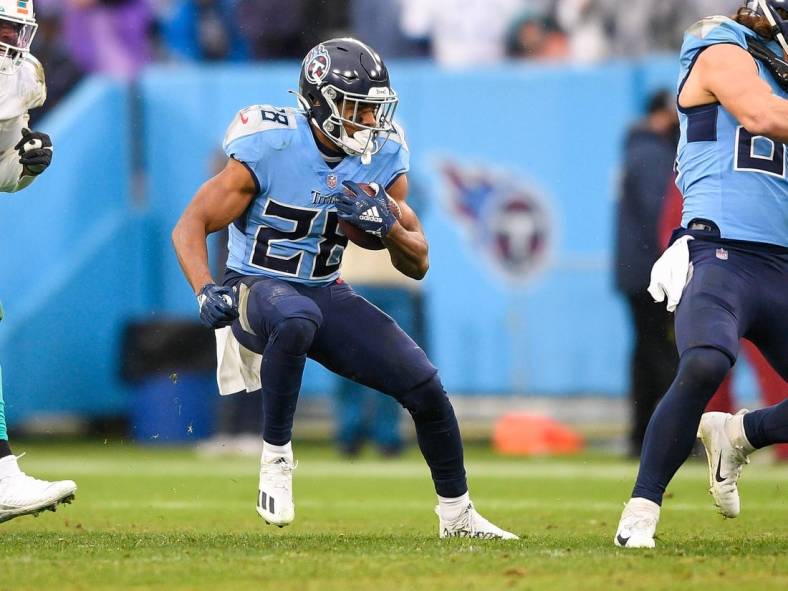 Jan 2, 2022; Nashville, Tennessee, USA;  Tennessee Titans running back Jeremy McNichols (28) runs against the Miami Dolphins during the second half at Nissan Stadium. Mandatory Credit: Steve Roberts-USA TODAY Sports