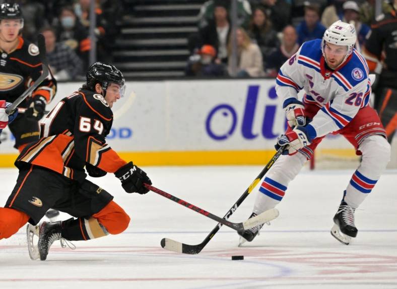 Jan 8, 2022; Anaheim, California, USA; Anaheim Ducks right wing Jacob Perreault (64) and New York Rangers left wing Tim Gettinger (26) battle for the puck in the third period of the game at Honda Center. Mandatory Credit: Jayne Kamin-Oncea-USA TODAY Sports