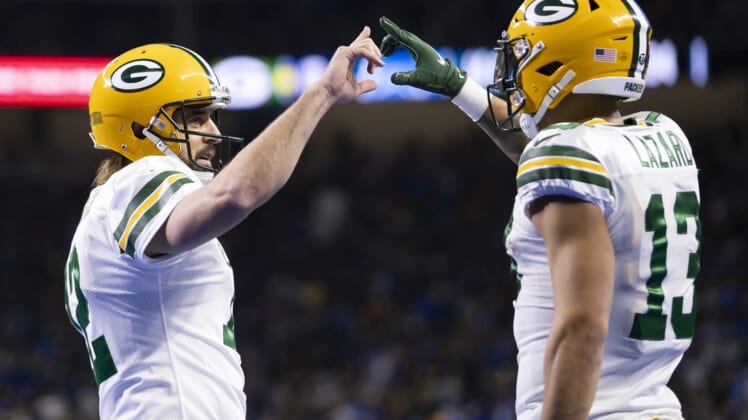 Jan 9, 2022; Detroit, Michigan, USA; Green Bay Packers wide receiver Allen Lazard (13) and quarterback Aaron Rodgers (12) celebrate together after connecting for a touchdown during the second quarter against the Detroit Lions at Ford Field. Mandatory Credit: Raj Mehta-USA TODAY Sports