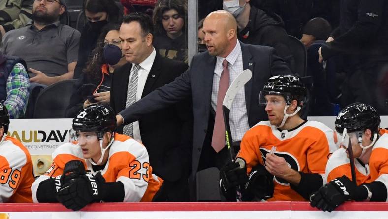 Feb 1, 2022; Philadelphia, Pennsylvania, USA; Philadelphia Flyers assistant head coach John Torchetti and interim head coach Mike Yeo behind the bench during the third period against the Winnipeg Jets at Wells Fargo Center. Mandatory Credit: Eric Hartline-USA TODAY Sports