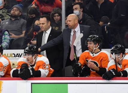 Feb 1, 2022; Philadelphia, Pennsylvania, USA; Philadelphia Flyers assistant head coach John Torchetti and interim head coach Mike Yeo behind the bench during the third period against the Winnipeg Jets at Wells Fargo Center. Mandatory Credit: Eric Hartline-USA TODAY Sports